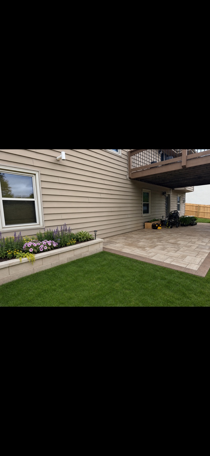 Finished residential paver patio and raised planter